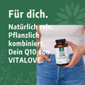 Frau hält Vitalove Coenzym Q10 Kapseln mit Maca Wurzelpulver, grüner Werbehintergrund, Text